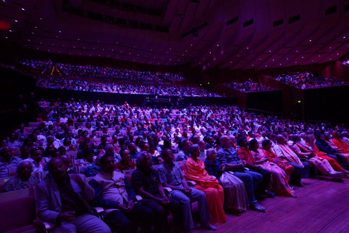 Concert audience — packed hall, purple light
